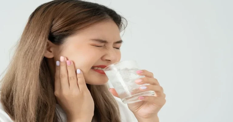 A picture of a woman having pain because of tooth sensitivity