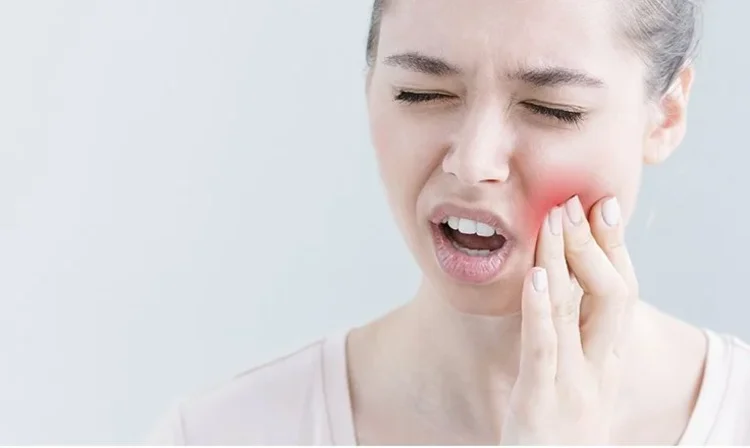 A picture of a woman with a dental emergency