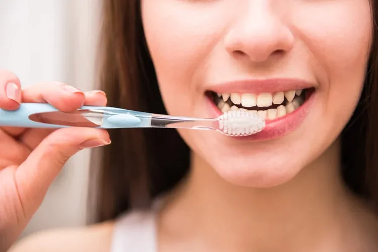 A picture of a woman taking care of her dental hygiene